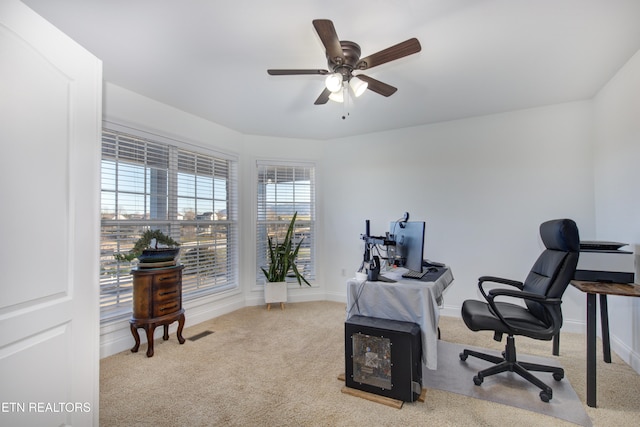 home office with ceiling fan and light colored carpet