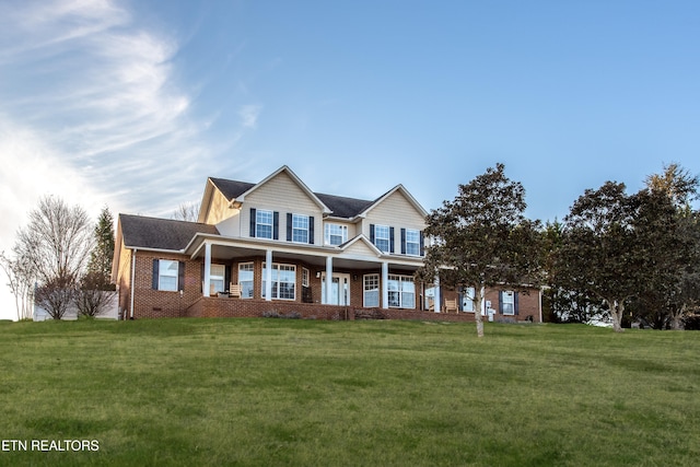 view of front of home with covered porch and a front yard