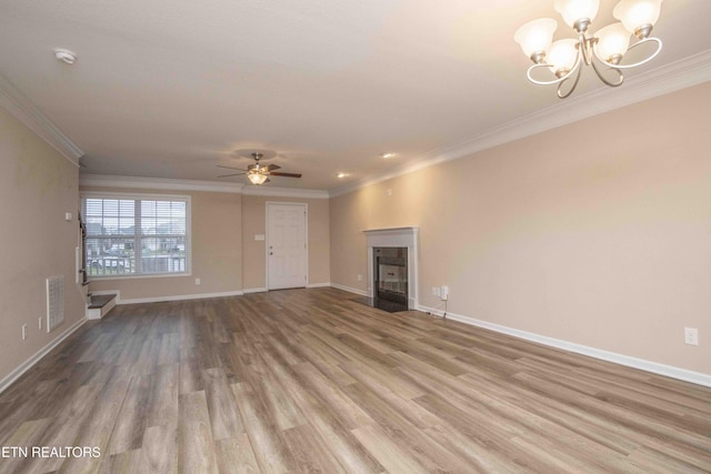 unfurnished living room with a high end fireplace, ceiling fan with notable chandelier, light hardwood / wood-style floors, and ornamental molding