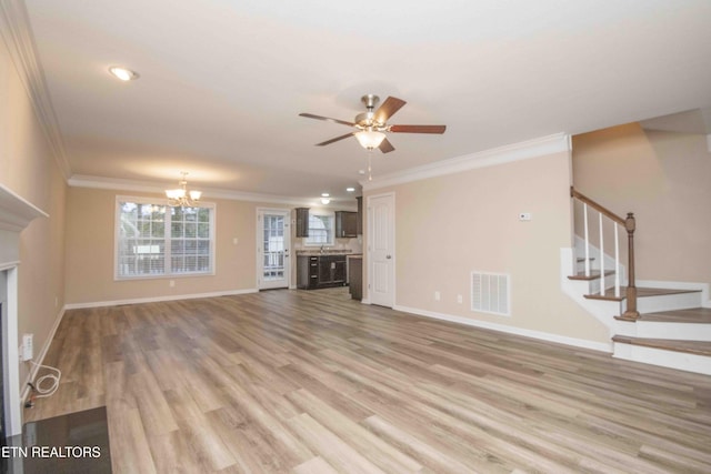 unfurnished living room featuring ceiling fan with notable chandelier, light hardwood / wood-style floors, and crown molding