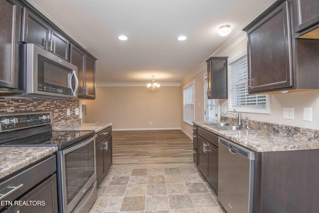 kitchen with an inviting chandelier, crown molding, sink, dark brown cabinets, and stainless steel appliances