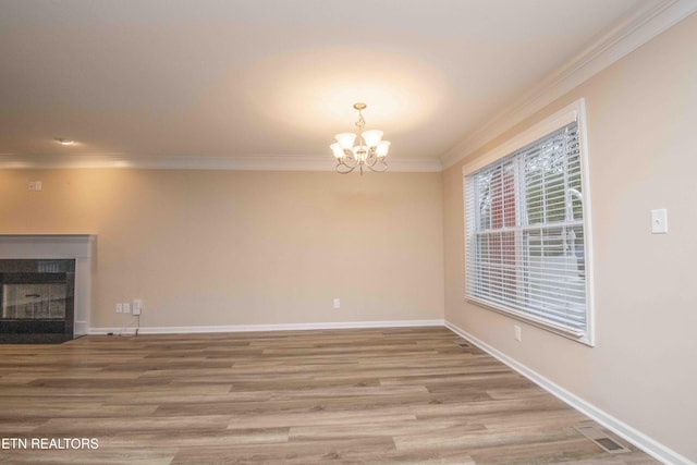 interior space with crown molding, wood-type flooring, and a notable chandelier