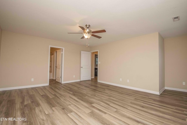 spare room featuring light hardwood / wood-style flooring and ceiling fan