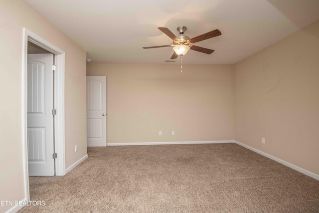 carpeted spare room with ceiling fan