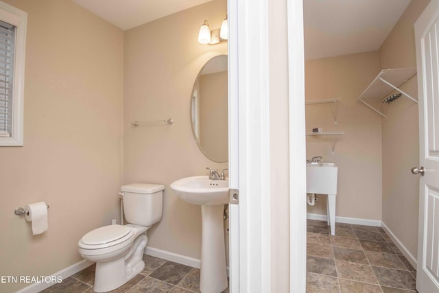 bathroom featuring toilet and sink