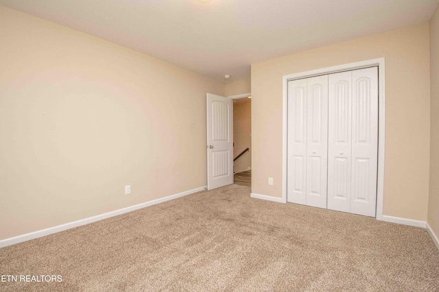 unfurnished bedroom with carpet and a closet