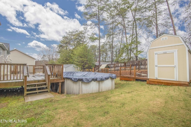 view of yard with a pool side deck and a shed