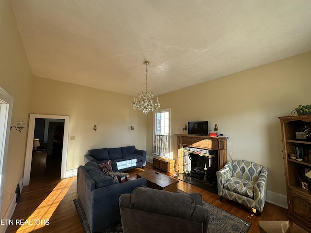 living room featuring hardwood / wood-style floors, a textured ceiling, and a chandelier