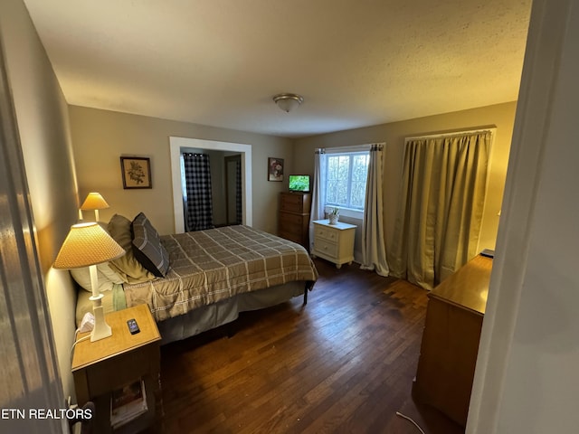 bedroom featuring dark hardwood / wood-style flooring