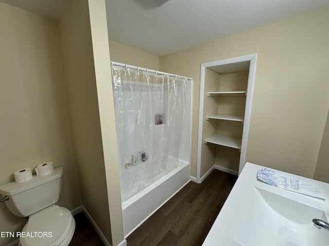 bathroom featuring hardwood / wood-style floors, shower / bath combination with curtain, and toilet