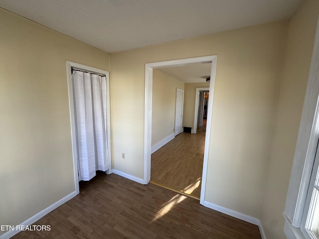 unfurnished bedroom with dark hardwood / wood-style flooring