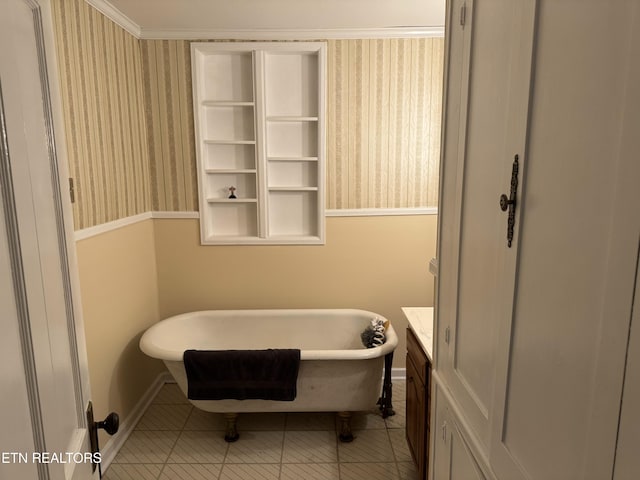 bathroom with tile patterned floors, vanity, crown molding, and a bath