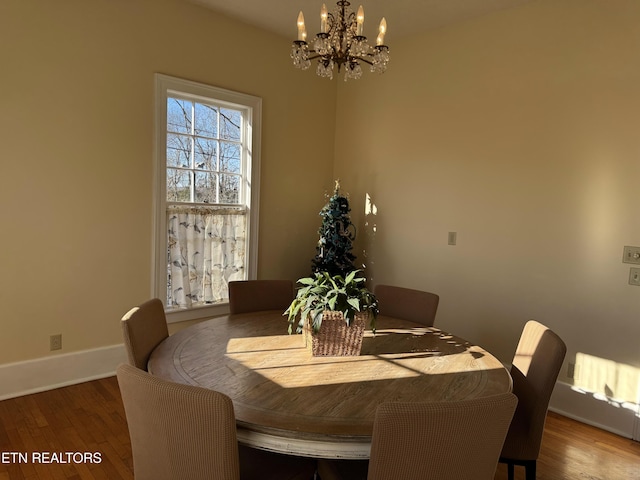 dining room featuring an inviting chandelier and hardwood / wood-style flooring