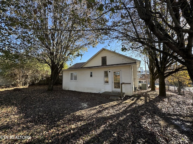 rear view of house featuring central AC