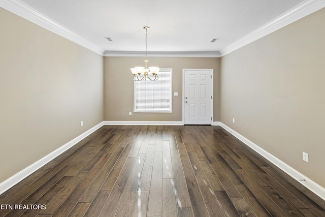 unfurnished dining area with a notable chandelier, ornamental molding, and dark wood-type flooring