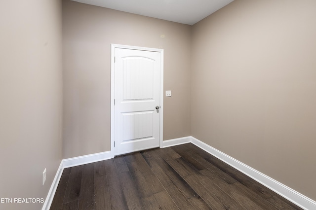 spare room with dark hardwood / wood-style flooring