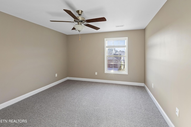 carpeted empty room featuring ceiling fan