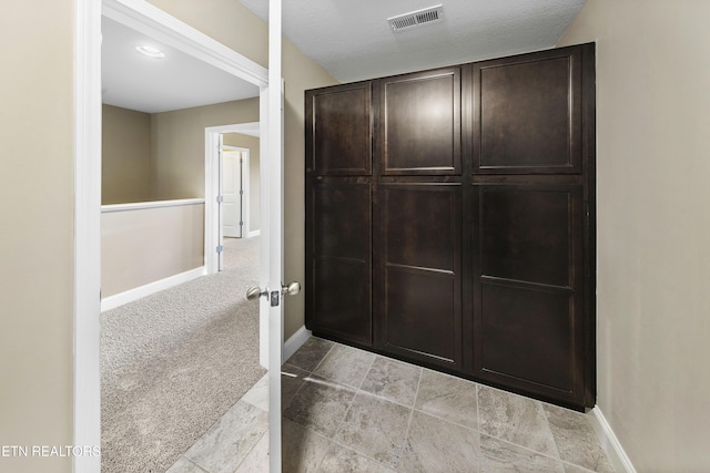 interior space featuring a textured ceiling