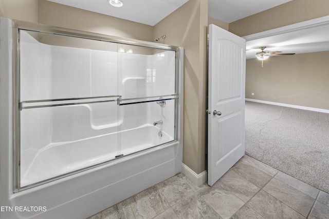 bathroom with ceiling fan and bath / shower combo with glass door