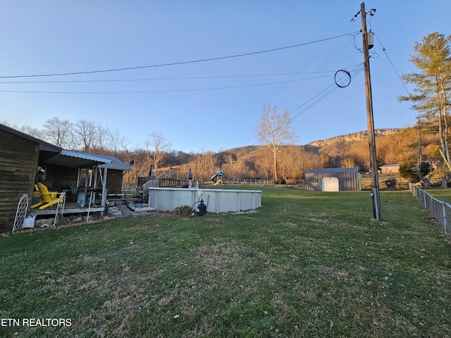 view of yard with a mountain view and a storage unit