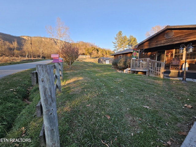 view of yard with a deck with mountain view