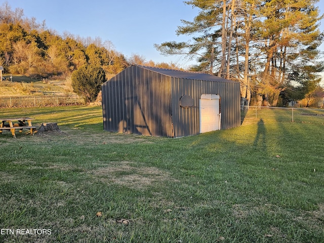 view of outbuilding featuring a lawn