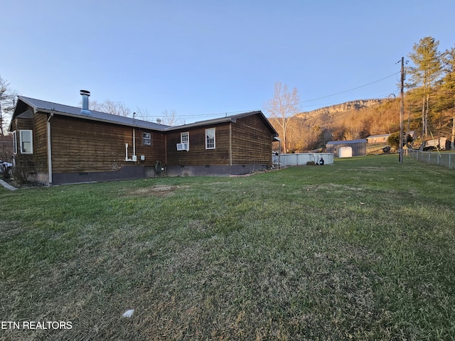 rear view of property featuring a lawn