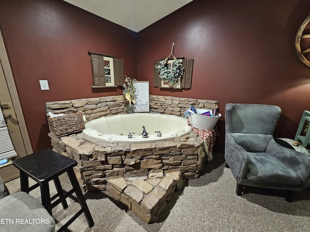 bathroom with a bathtub and vaulted ceiling