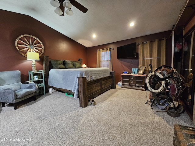 bedroom featuring a textured ceiling, ceiling fan, carpet floors, and vaulted ceiling