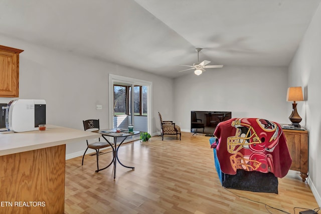 interior space featuring light wood-type flooring, vaulted ceiling, and ceiling fan