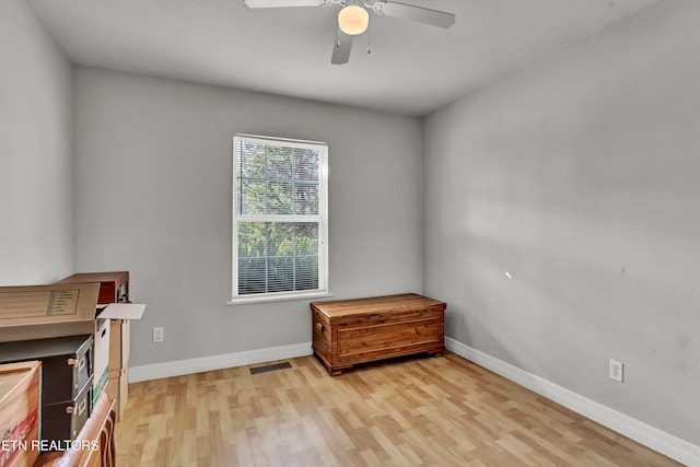 sitting room with ceiling fan and light hardwood / wood-style flooring