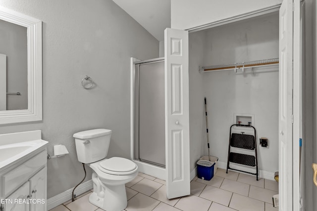 bathroom featuring tile patterned floors, heating unit, an enclosed shower, toilet, and vanity