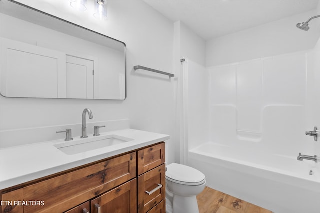 full bathroom with toilet, shower / bath combination, hardwood / wood-style flooring, and vanity