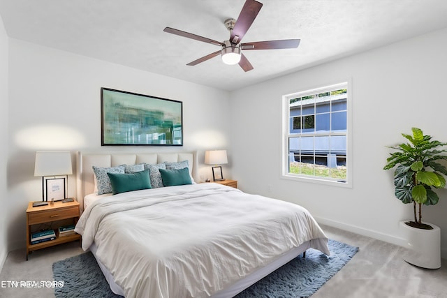 bedroom featuring ceiling fan and light carpet