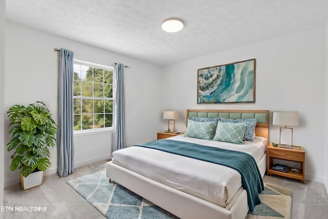 bedroom featuring light carpet