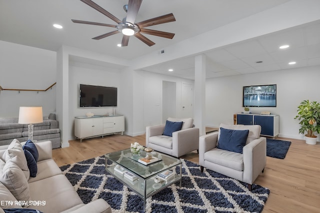 living room featuring ceiling fan and hardwood / wood-style floors