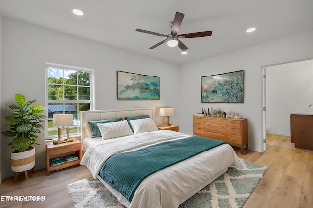 bedroom with ceiling fan and light hardwood / wood-style flooring