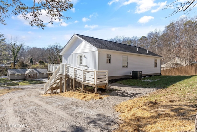 view of side of property with central AC and a deck