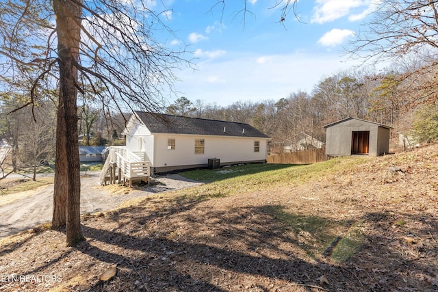 exterior space featuring central AC and a storage unit