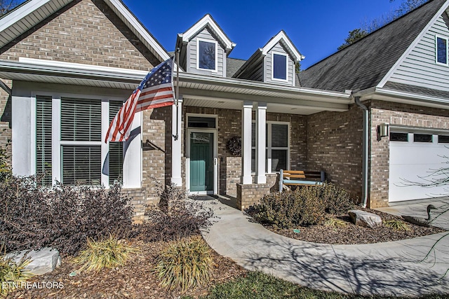 view of front facade featuring a porch and a garage