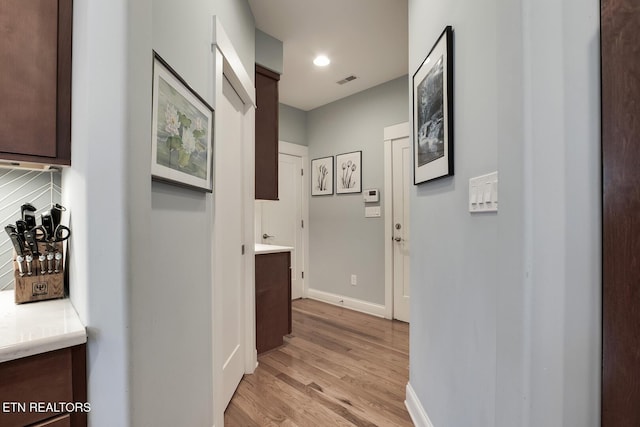 corridor with light wood-type flooring