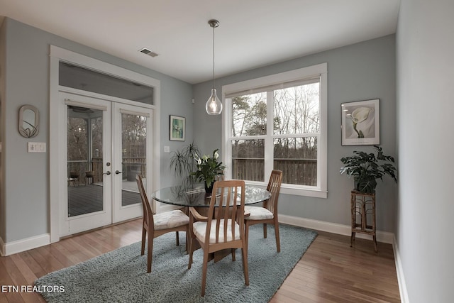 dining room featuring hardwood / wood-style floors and french doors