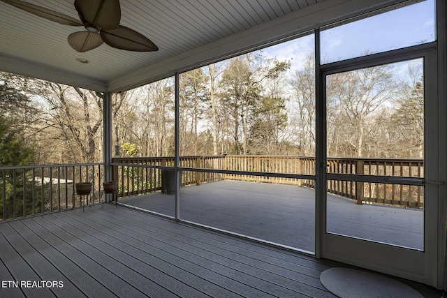 unfurnished sunroom with ceiling fan