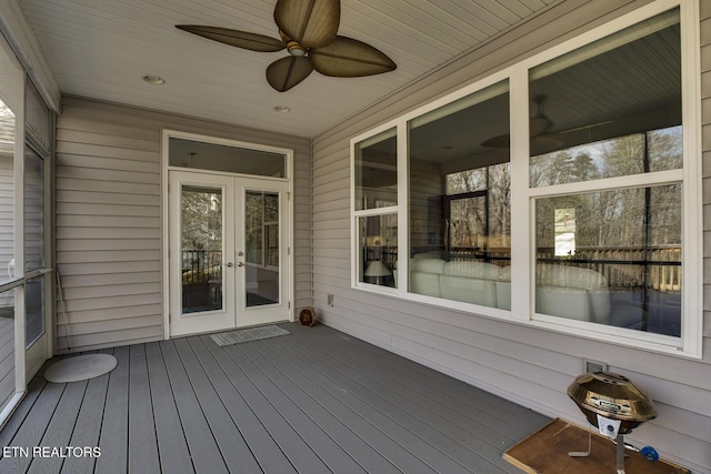 wooden deck featuring ceiling fan and french doors