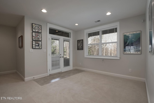 carpeted foyer entrance with french doors