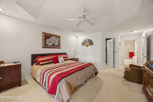 carpeted bedroom featuring ensuite bathroom and ceiling fan