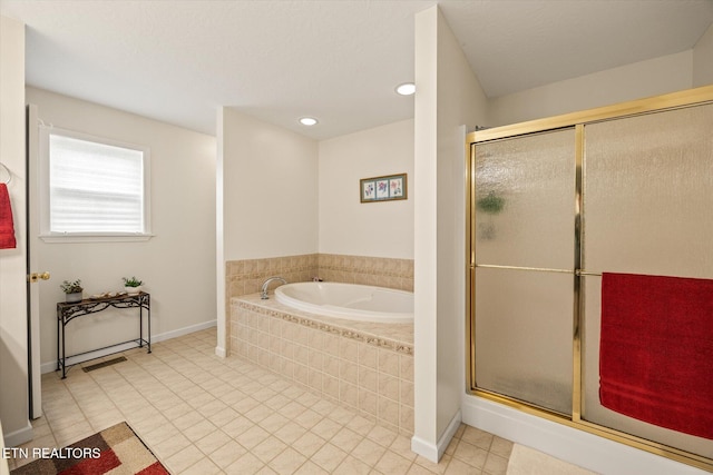 bathroom with tile patterned flooring and independent shower and bath