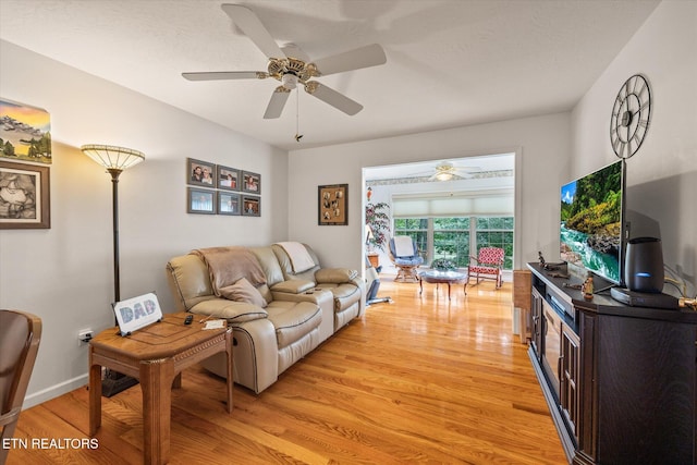 living room with ceiling fan and light hardwood / wood-style floors