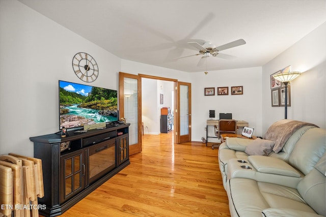 living room with ceiling fan, french doors, and light hardwood / wood-style floors