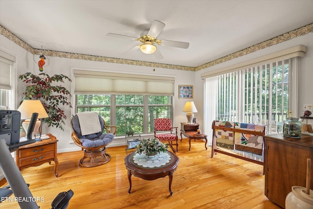 living area featuring ceiling fan, a healthy amount of sunlight, and wood-type flooring